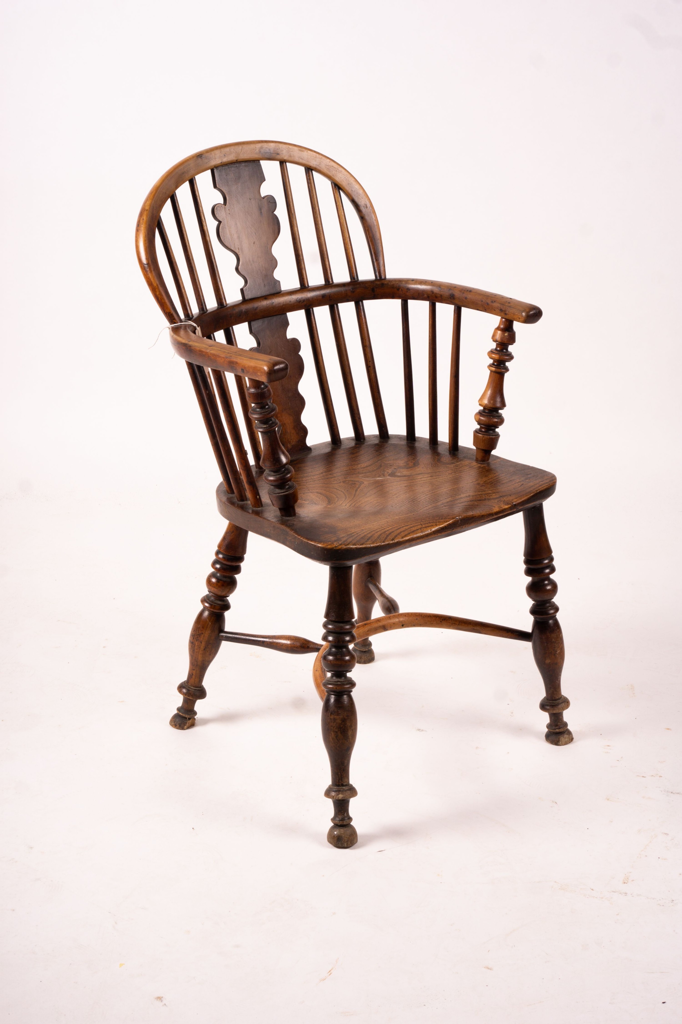 A mid 19th century yew and elm Windsor elbow chair with crinoline stretcher, width 54cm, depth 46cm, height 94cm